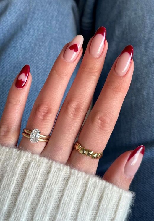 Elegant Nail Design: Deep Red and Soft Pink with Heart Accents for a Romantic Touch.