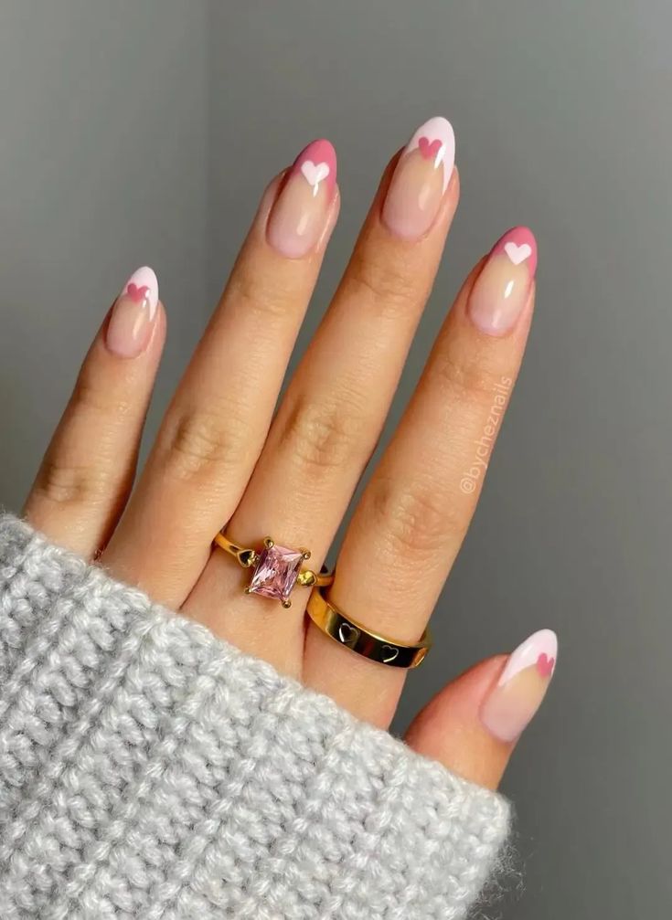 Trendy Chic Nail Design: Soft Pink Tips with Heart Accents for a Playful Aesthetic.