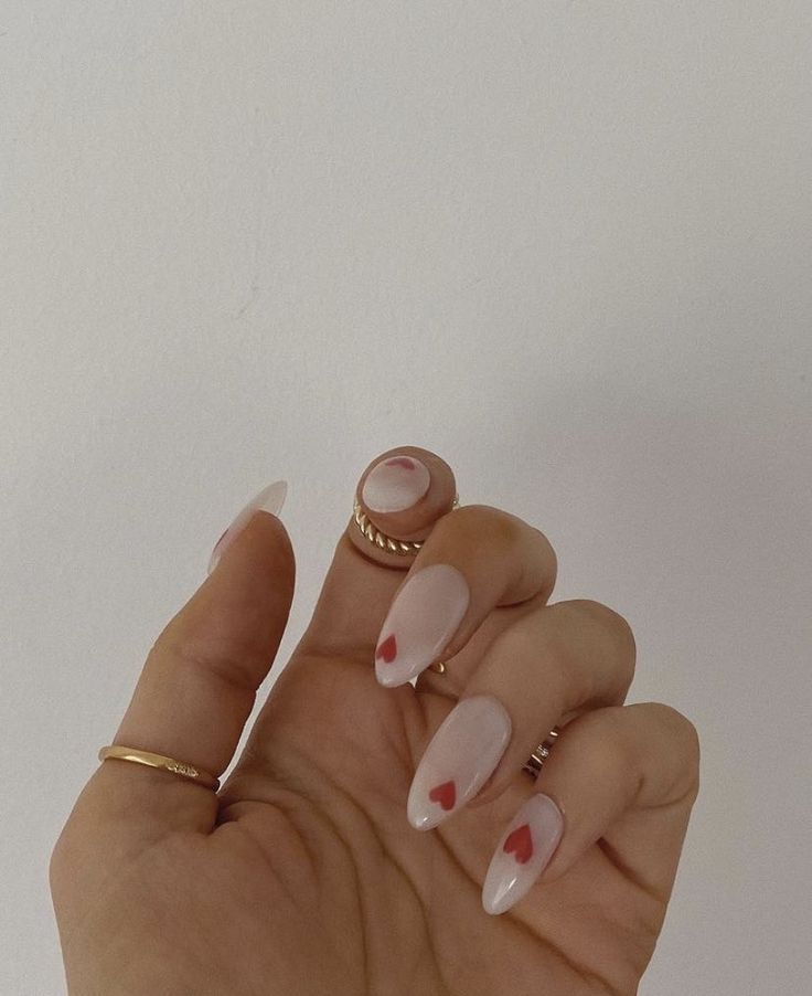 Romantic Nude Nail Design with Whimsical Red Heart Accents