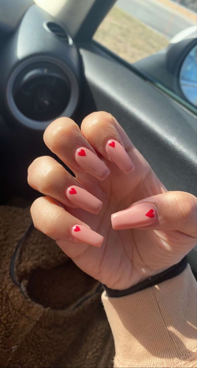 Elegant Nude Nail Design with Charming Red Heart Accents