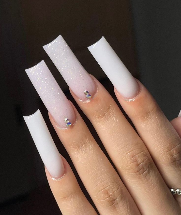 Elegant Gradient Long Nails in Soft White and Glittery Pink with Rhinestone Accents.