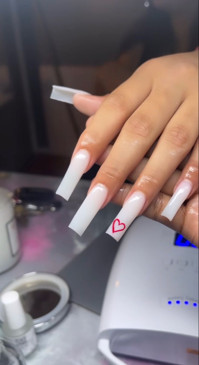 Elegant White Tip Acrylic Nails with Ombre Pink and Playful Red Heart Accent.