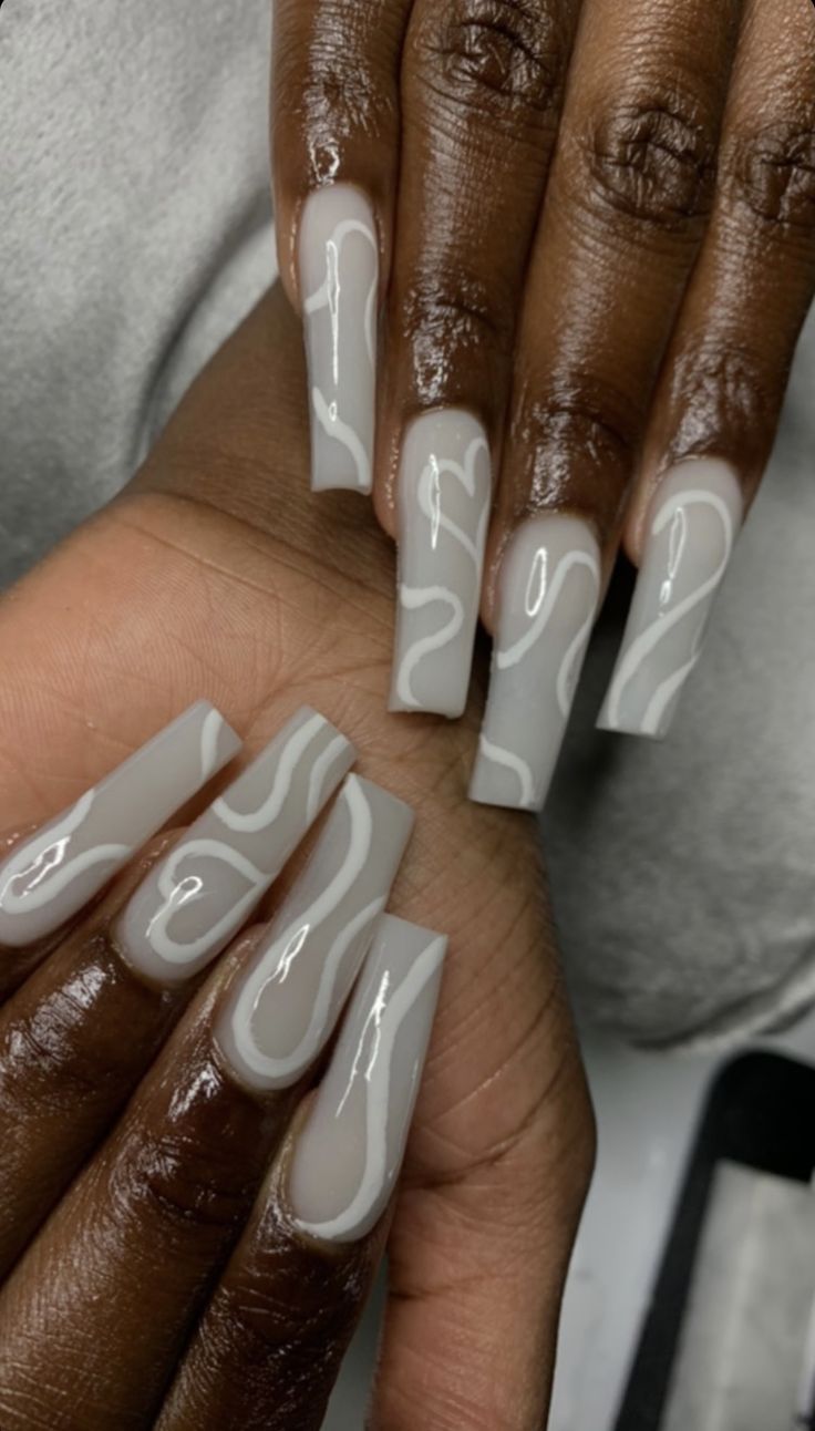 Elegant Gray-Based Long Nails with Artistic White Swirls for a Chic Manicure.