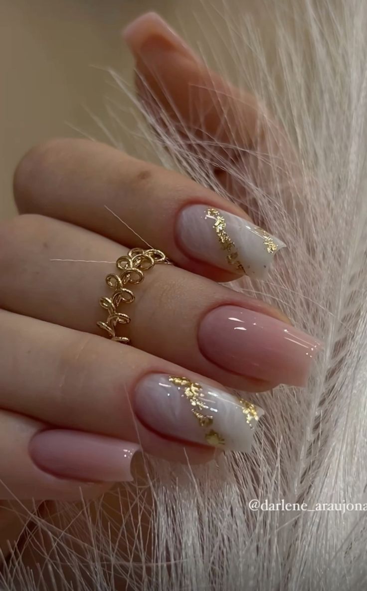 Sophisticated Nail Design: Soft Pink and Creamy White with Luxurious Gold Accents.