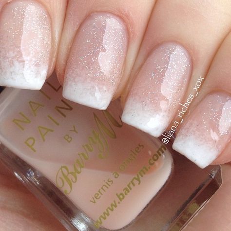 Elegant Ombre Nail Design: Light Pink to White Gradient with Subtle Sparkle.