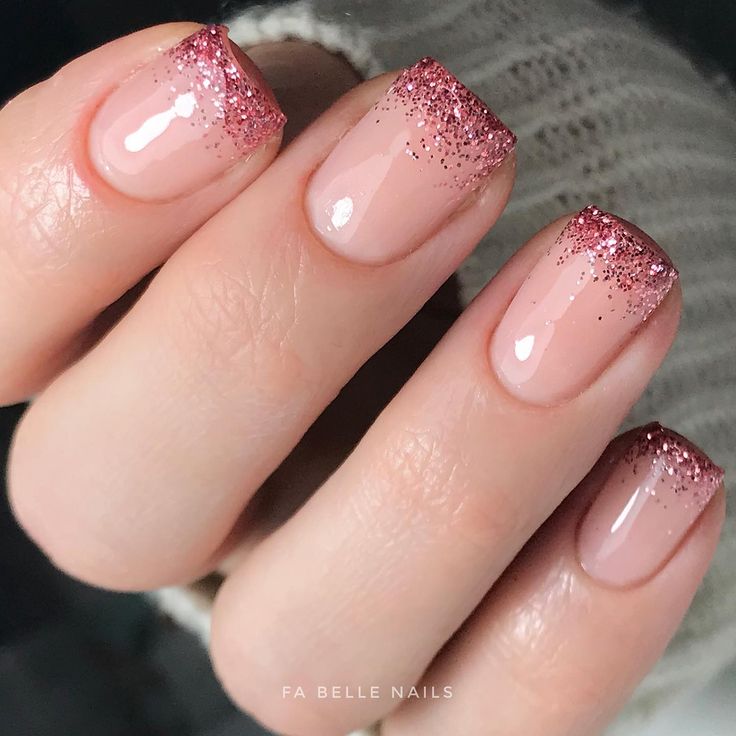 Elegant Glittery Ombre Nail Design: Delicate Pink Base with Sparkling Rose Gold Tips.