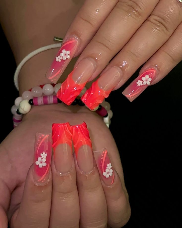 Playful Pink and Orange Nail Design with Elegant White Floral Accents.