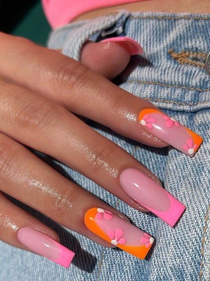 Playful Vibrant Nail Design with Pastel Pink and Bold Orange Floral Accents.