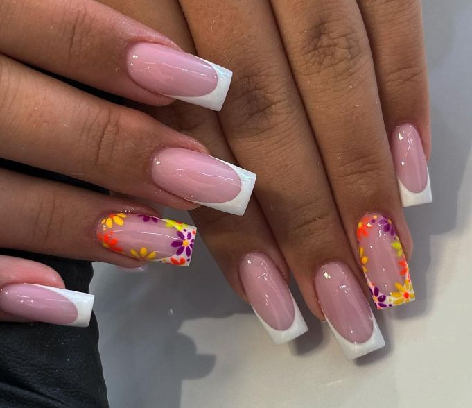 Elegant Soft Pink and White Nail Design with Vibrant Floral Accents.