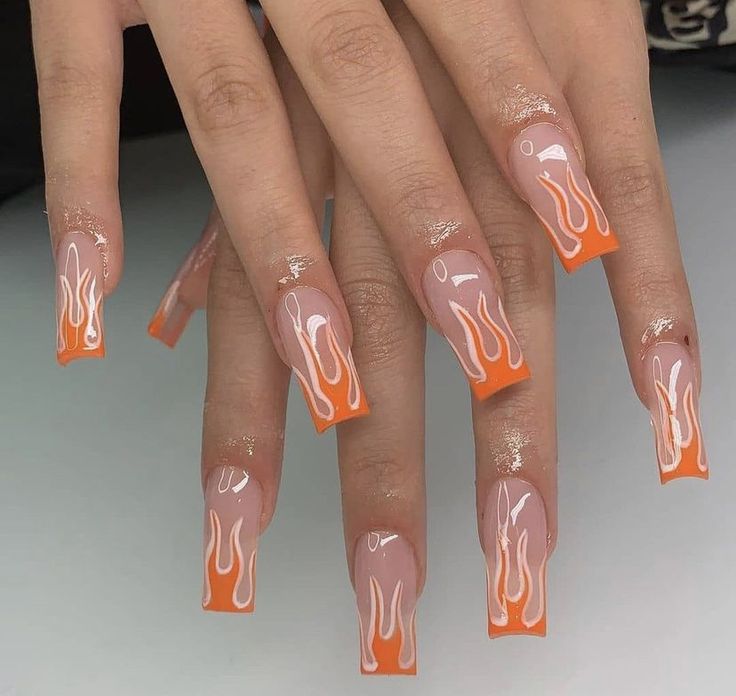 Vibrant Flame-Inspired Nail Design with Orange Gradient and Playful Motif