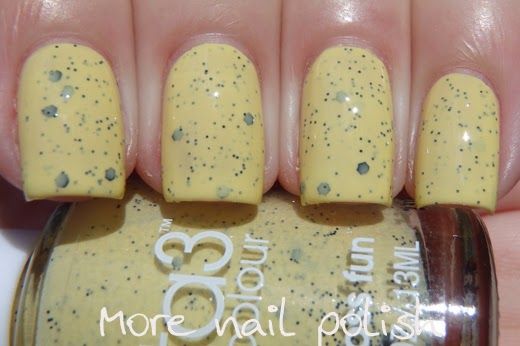 Vibrant Yellow Nail Polish with Sparkly Dark Accents for a Playful Manicure.