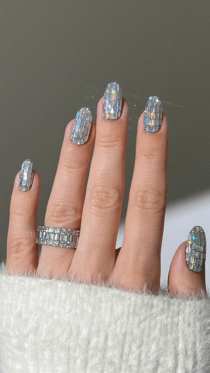 Elegant Sparkling Holographic Nail Design with Rectangular Shapes and Chic Ring Accents.