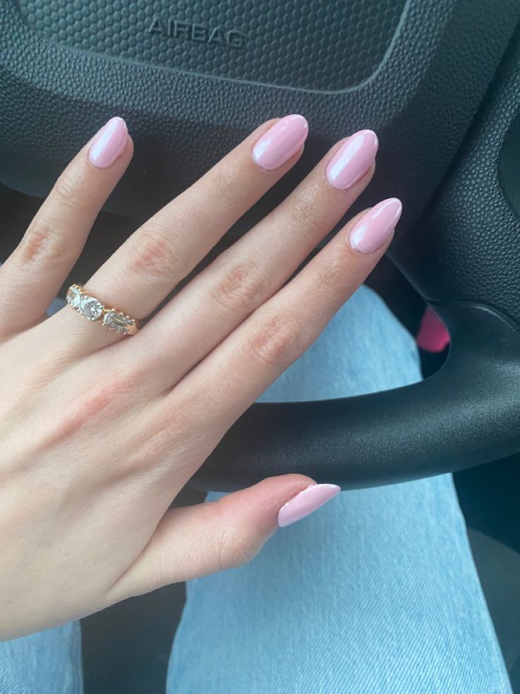 Elegant Almond-Shaped Pastel Pink Nails Paired with a Sparkling Ring.