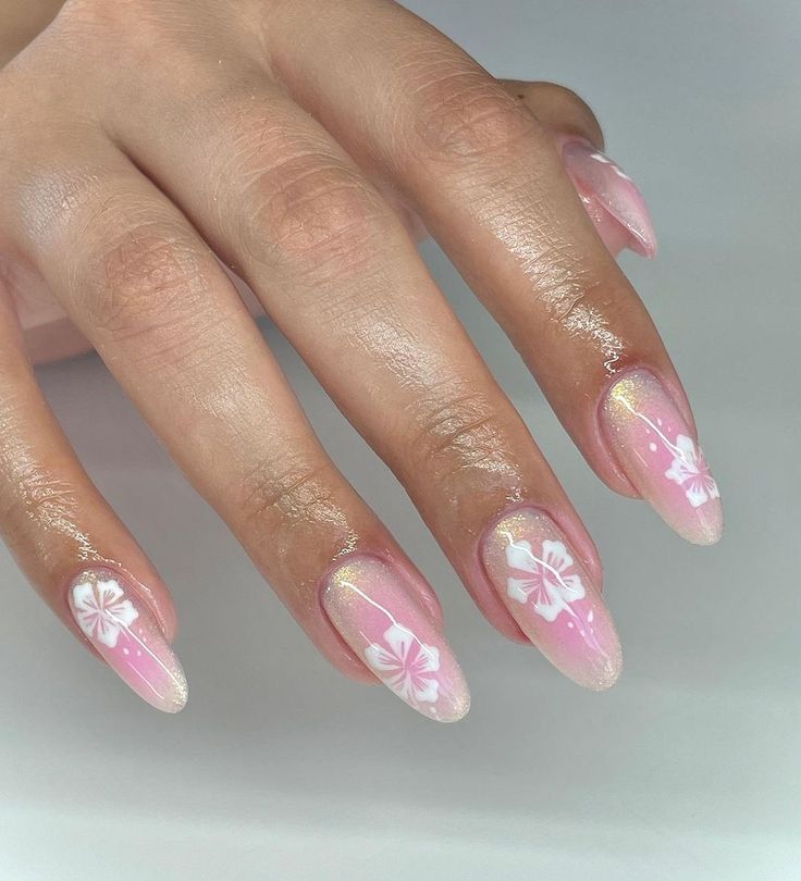 Chic Soft Pink Nail Design with Whimsical White Floral Accents for Spring/Summer.