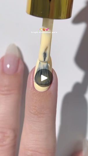 Vibrant Yellow Nail Design with Black Brush Strokes for a Tropical Flair.