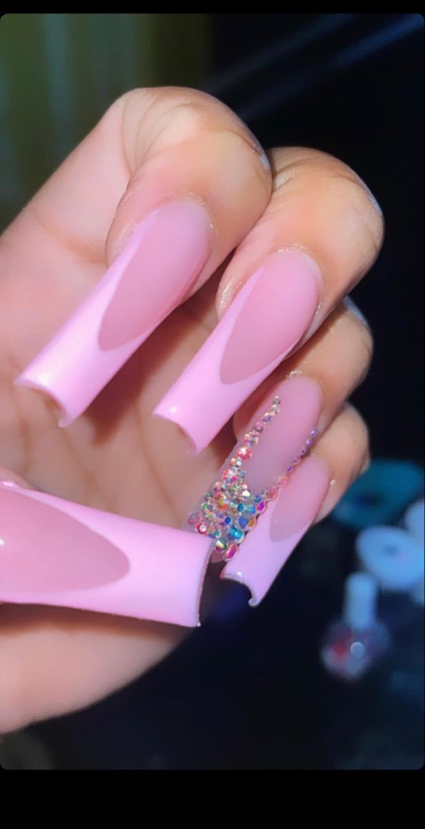 Chic Soft Pink Nail Design with Artistic Cut-Outs and Colorful Rhinestones