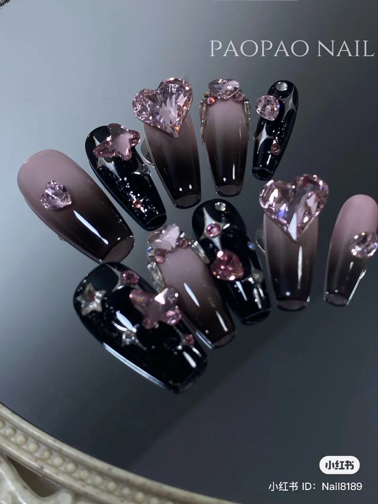 Chic Ombre Nail Design: Glamorous Pink and Black with Heart and Star Embellishments