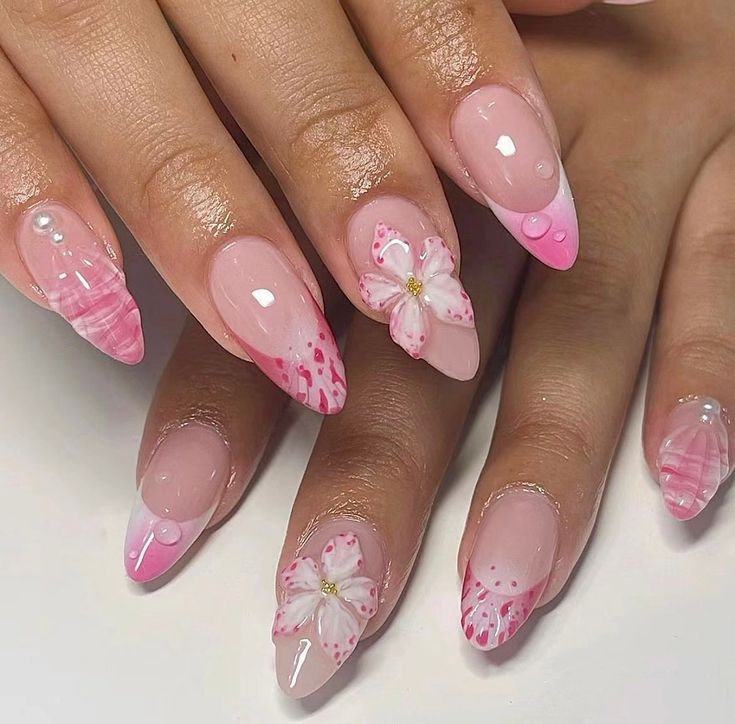 Elegant Soft Pink Floral Nail Design with Glossy Finish and Pearlescent Accents.