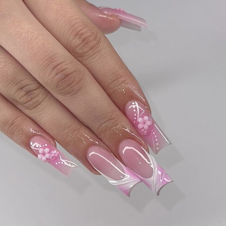 Sophisticated Long Coffin Nail Design with Soft Pink, White Accents, and Floral Embellishments.