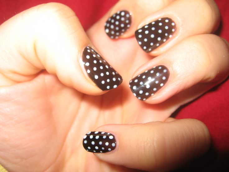 Chic Polka Dot Nail Design: Bold Black Base with Playful White Dots.