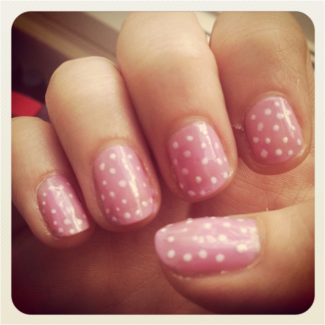 Cheerful Polka Dot Nail Design: Soft Pink Base with Whimsical White Dots.