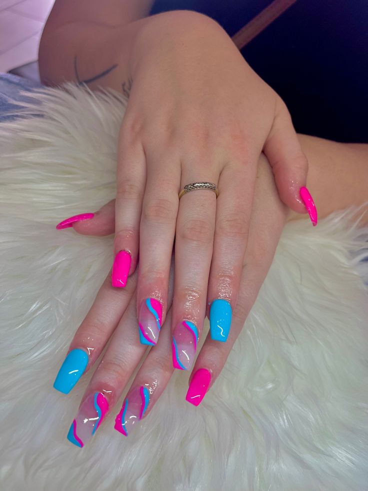 Bold Pink and Blue Nail Design with Playful Swirls and Glossy Finishes.