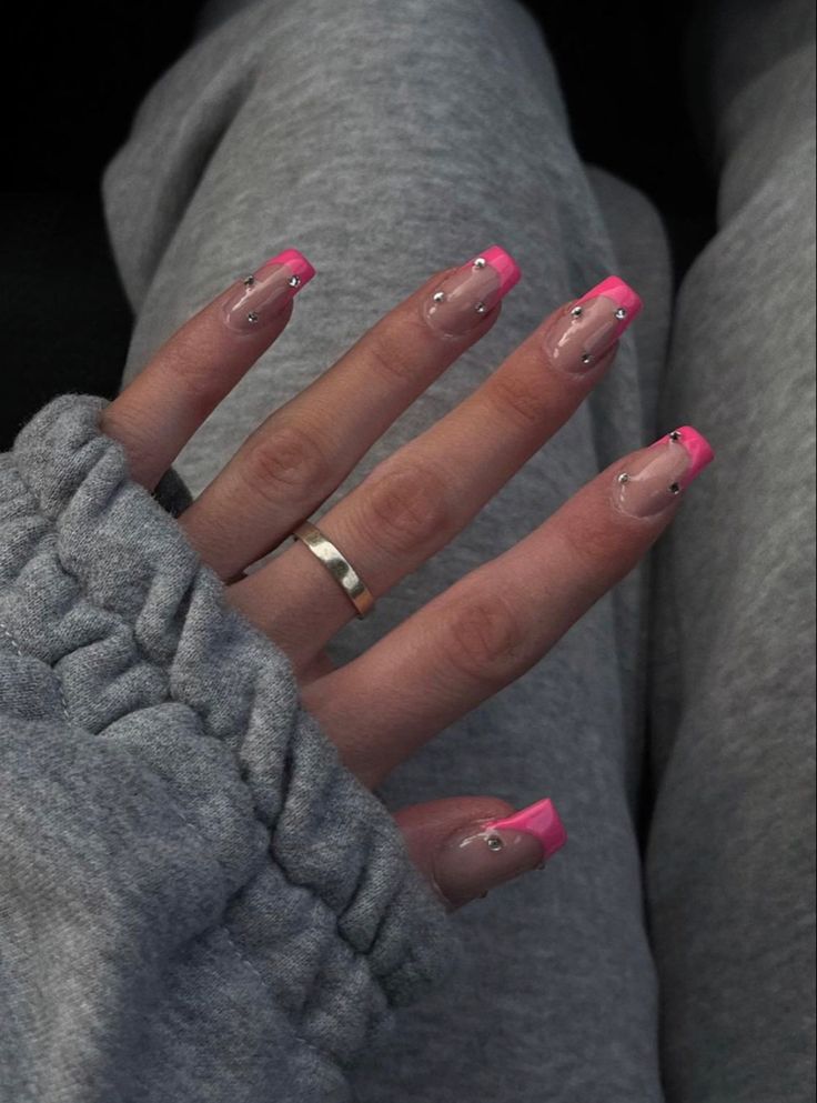 Chic Nude and Pink Nail Design with Rhinestone Accents for a Playful yet Sophisticated Look.