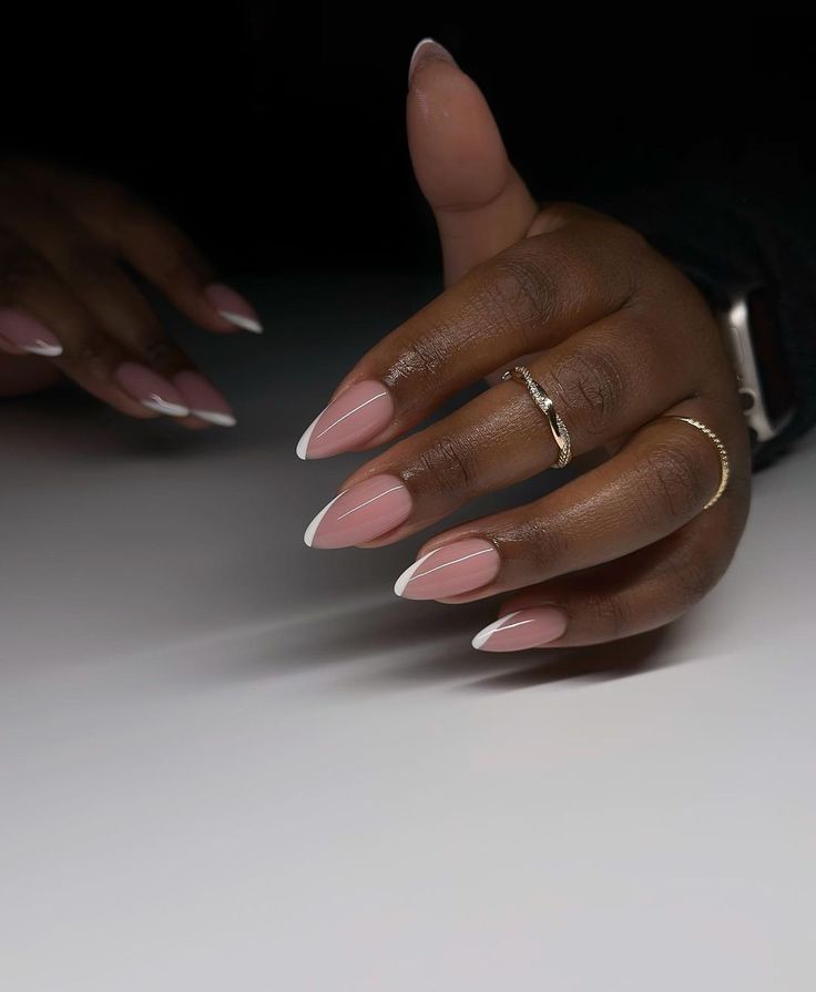 Sophisticated Almond-Shaped Nail Design with Nude Base and White French Tips.