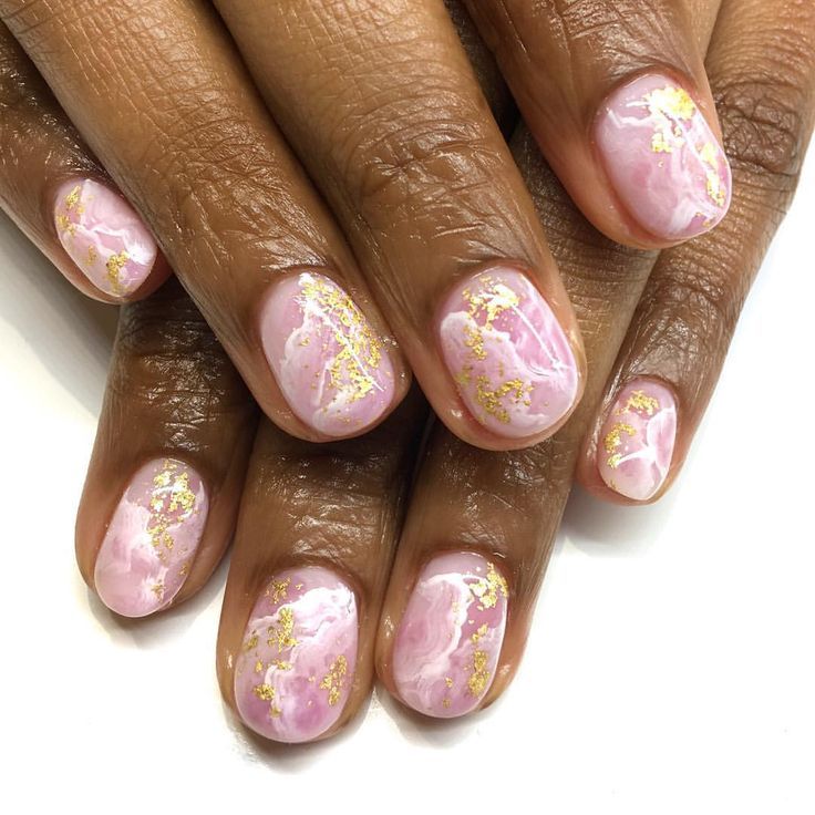 Sophisticated Marble Nail Design with Soft Pink Base and Gold Foil Accents.