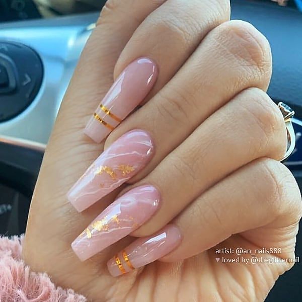 Chic Soft Pink Nail Design with Gold Accents and Tapered Shape.