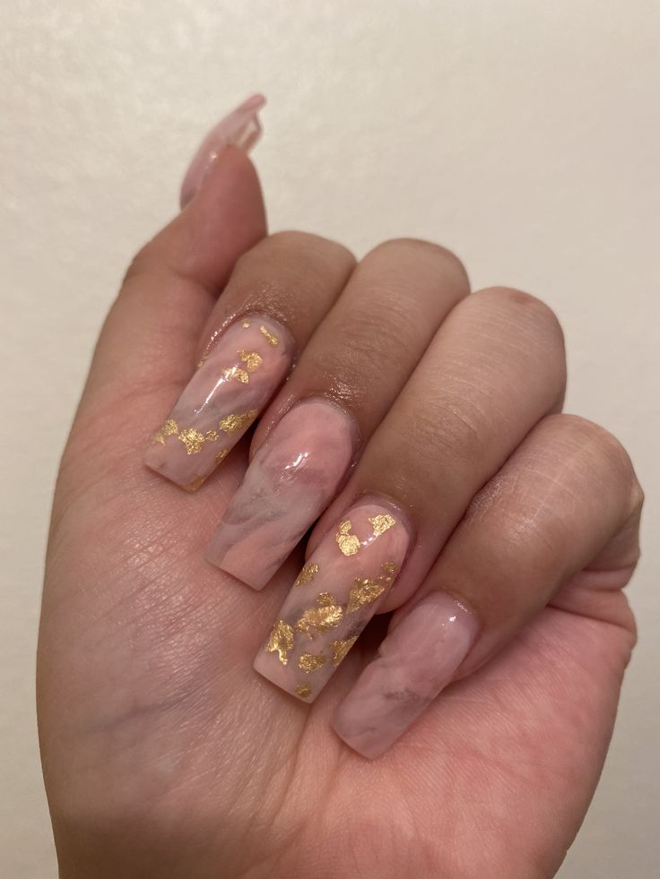 Chic Soft Pink and Marble Nail Design with Luxurious Gold Foil Accents.