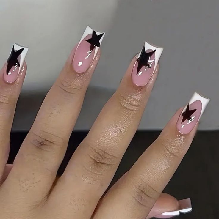 Chic Nude Nail Design with Bold Black Stars and Glossy French Tips.