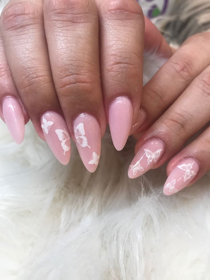 Elegant Pink Nails with Intricate White Butterfly Designs for a Playful Aesthetic.