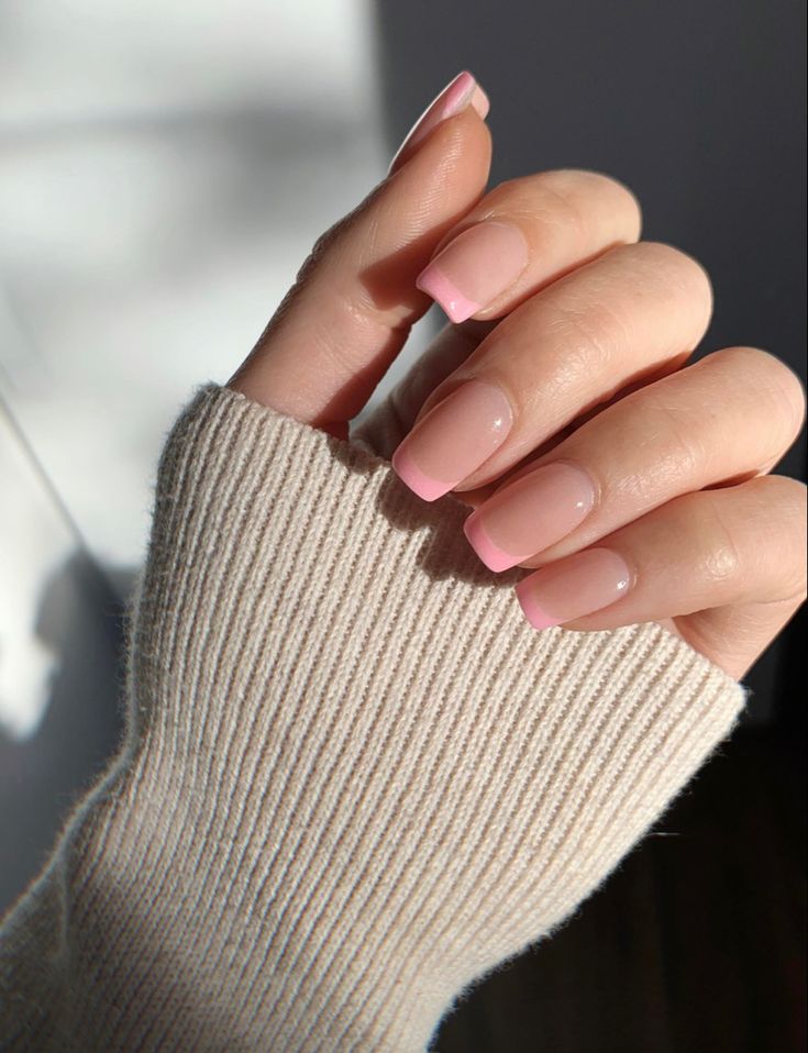 Elegant Chic Nail Design: Soft Nude Base with Delicate Pink French Tips.