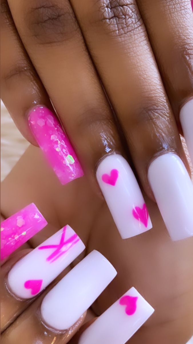 Playful Pink and White Nail Design with Sparkling Glitter and Heart Motifs.