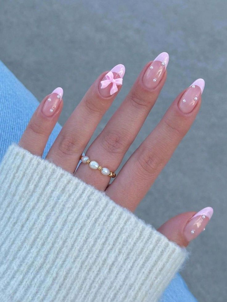 Chic Elegant Nail Design with Soft Pink Tips, Pearls, and a Bow.