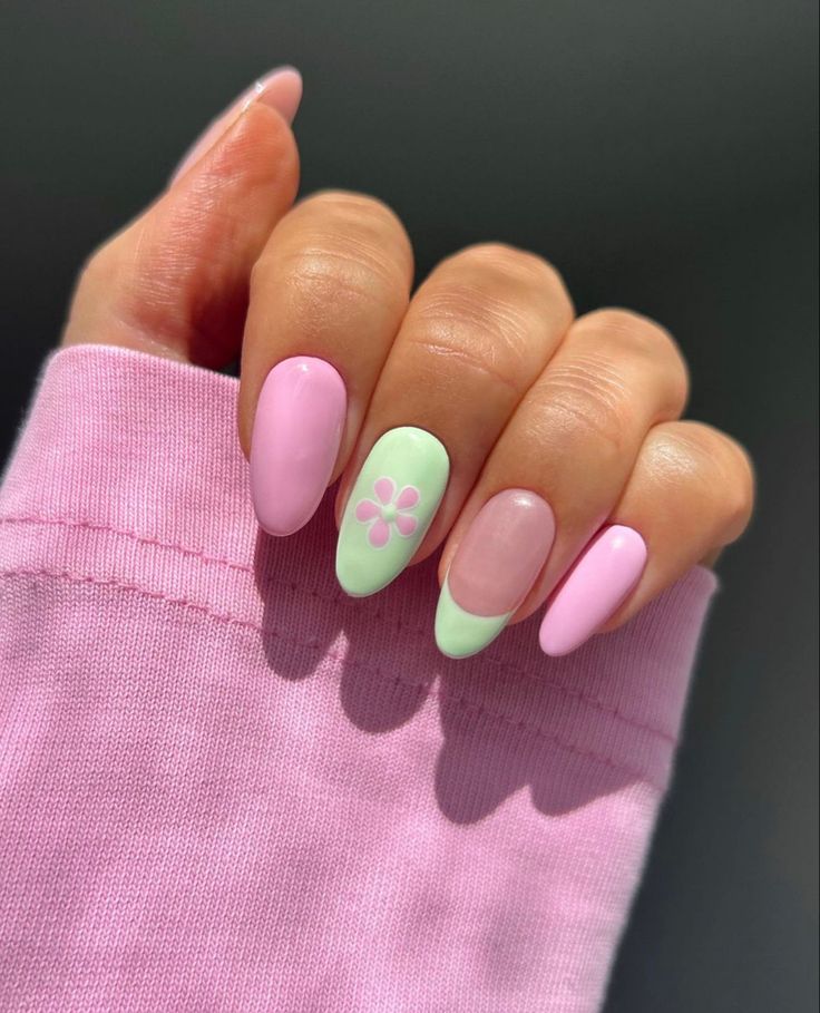 Playful Pastel Almond Nail Design with Floral Accents for Spring/Summer.