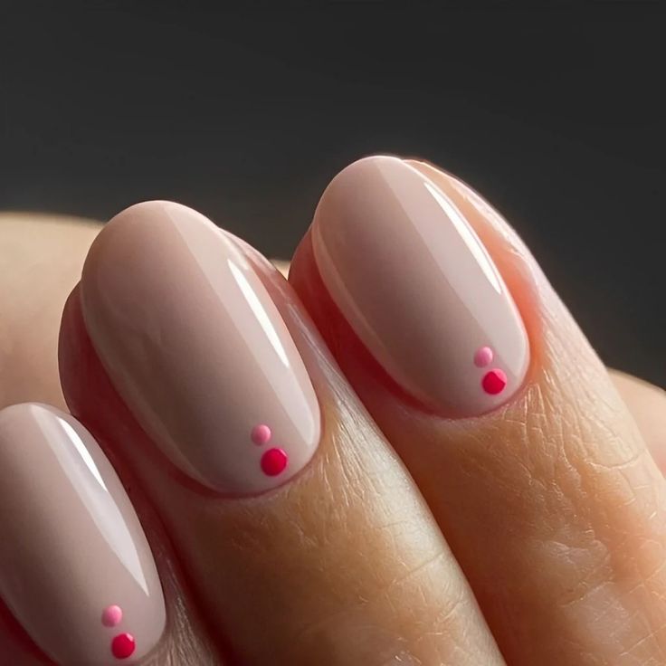 Chic Elegant Nude Manicure with Glossy Finish and Playful Pink Accents