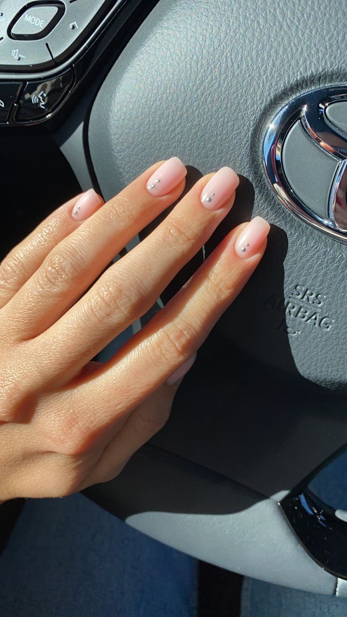 Elegant Nude Nails with Glossy Finish and Subtle Pearl Accents for a Sophisticated Touch