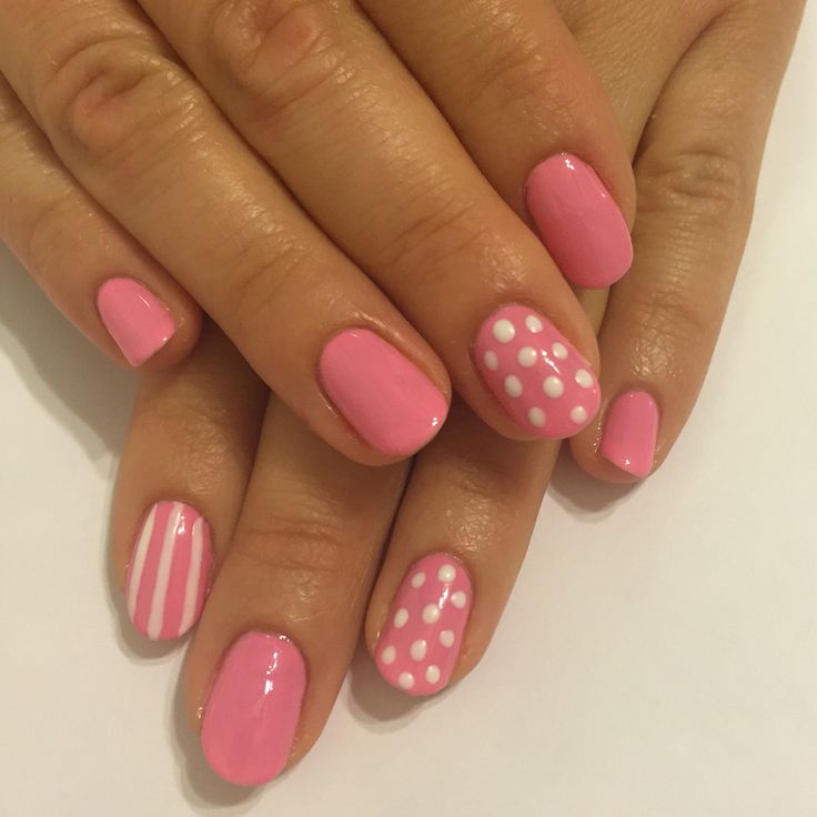 Whimsical Pink Manicure with Polka Dots and Stripes for Any Occasion