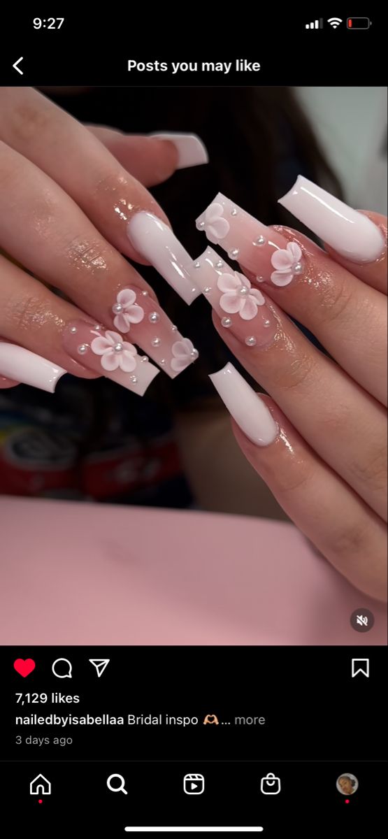 Elegant Bridal Nail Design: Soft Pink and White Tips with Floral and Rhinestone Accents.