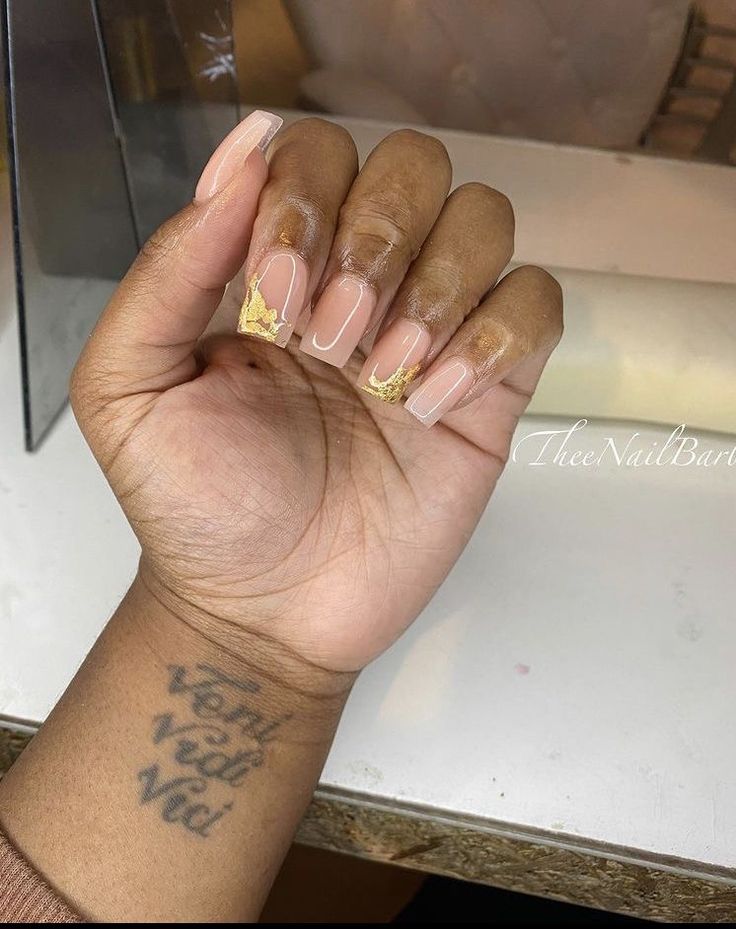 Chic Nude Nails with Gold Detailing for a Sophisticated Manicure.