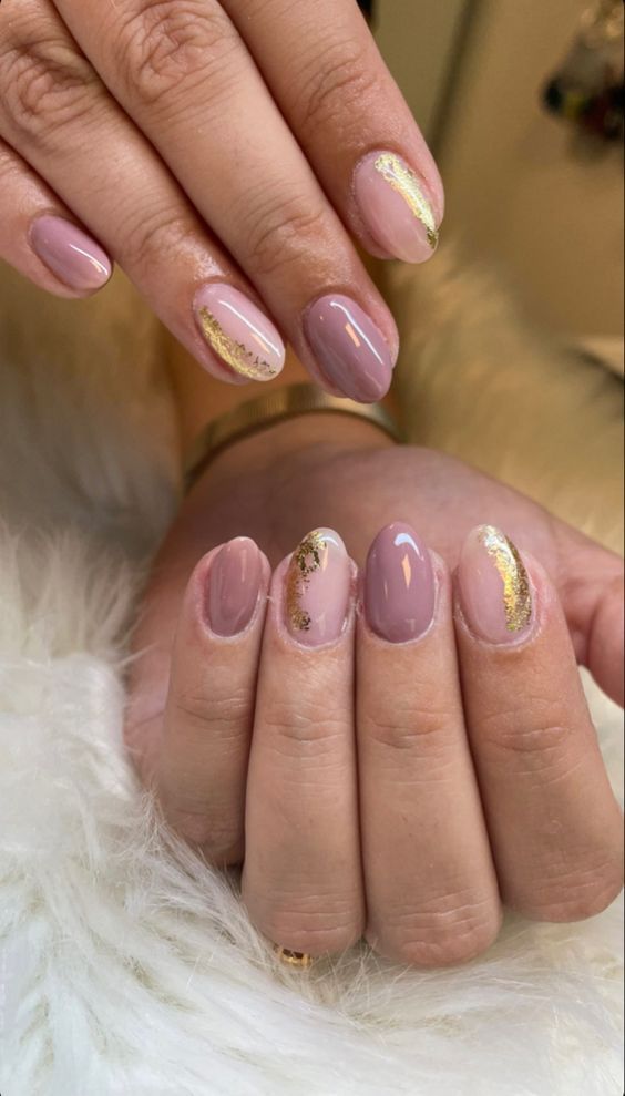 Chic Nude and Light Pink Nail Design with Glamorous Gold Accents and Varied Finishes