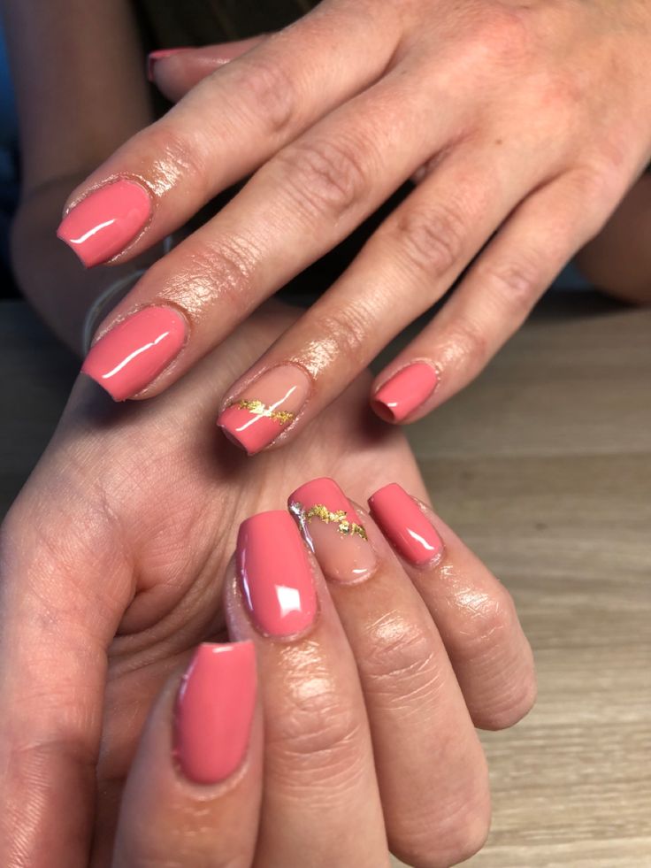 Chic Coral Nail Design with Elegant Gold Accents for a Modern Look.