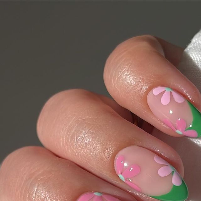 Delicate Pink Floral Nail Design with Soft Green Accents for a Fresh Spring/Summer Look.