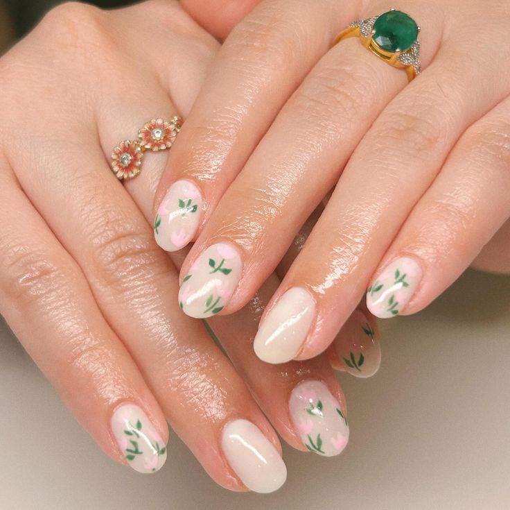 Elegant Floral Nail Design with Pastel Shades and Delicate Green Leaves