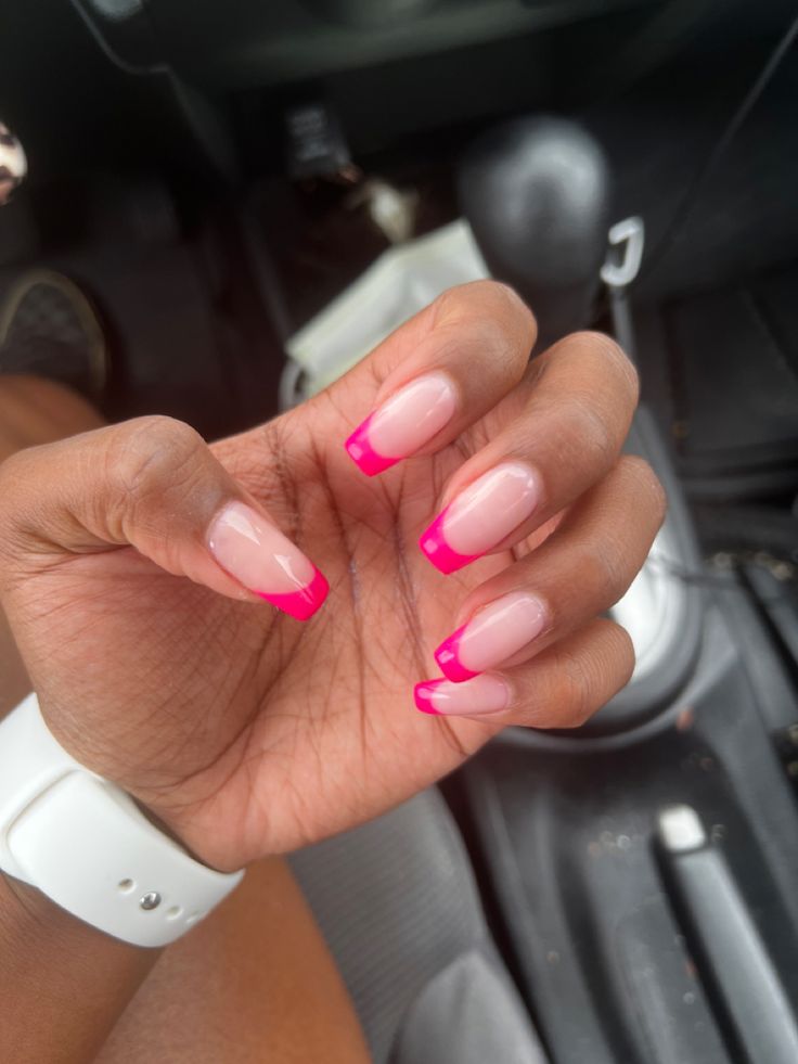 Vibrant Pink French Manicure with Elongated Tips: A Playful Elegance for Any Occasion.