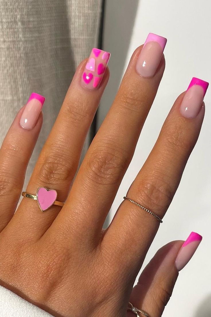 Fun and Trendy Vibrant Pink Tip Nail Design with Playful Patterns and Heart Motifs.