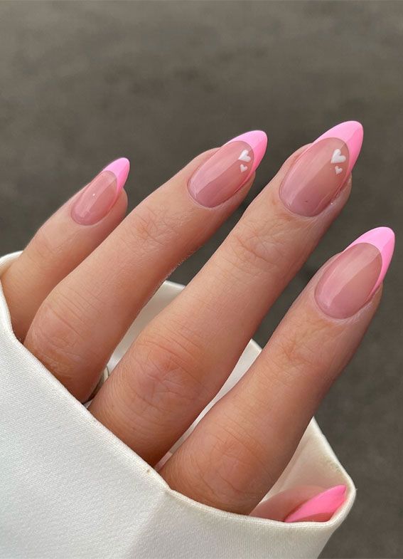 Charming Nail Design: Soft Transparent Base with Vibrant Pink Tips and Heart Patterns.