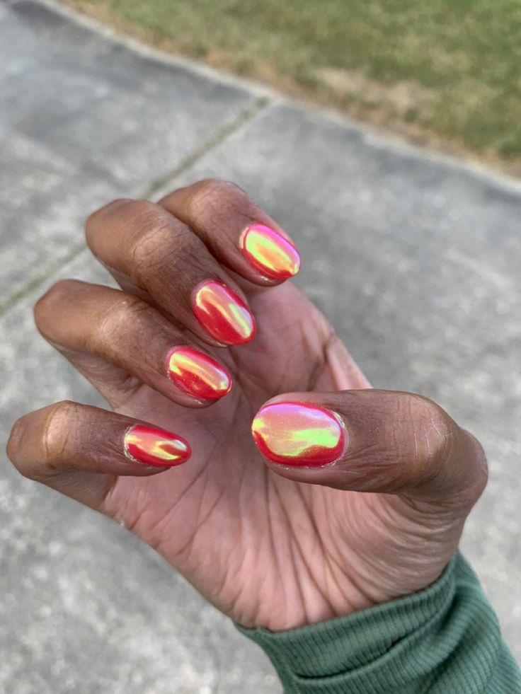 Bold Iridescent Nail Art: Vibrant Pink and Gold Hues with Glossy Finish